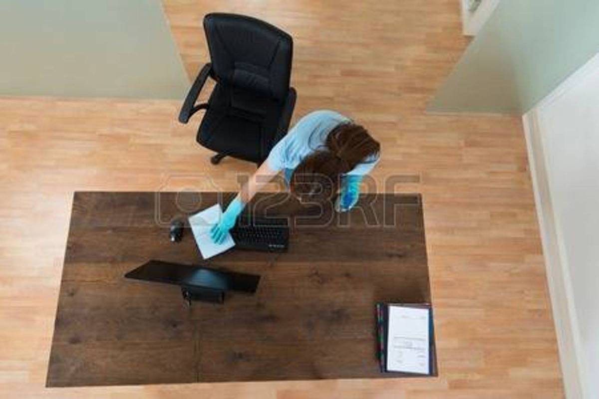 43694359-hoog-standpunt-van-jonge-vrouw-schoonmaken-keyboard-in-kantoor-1